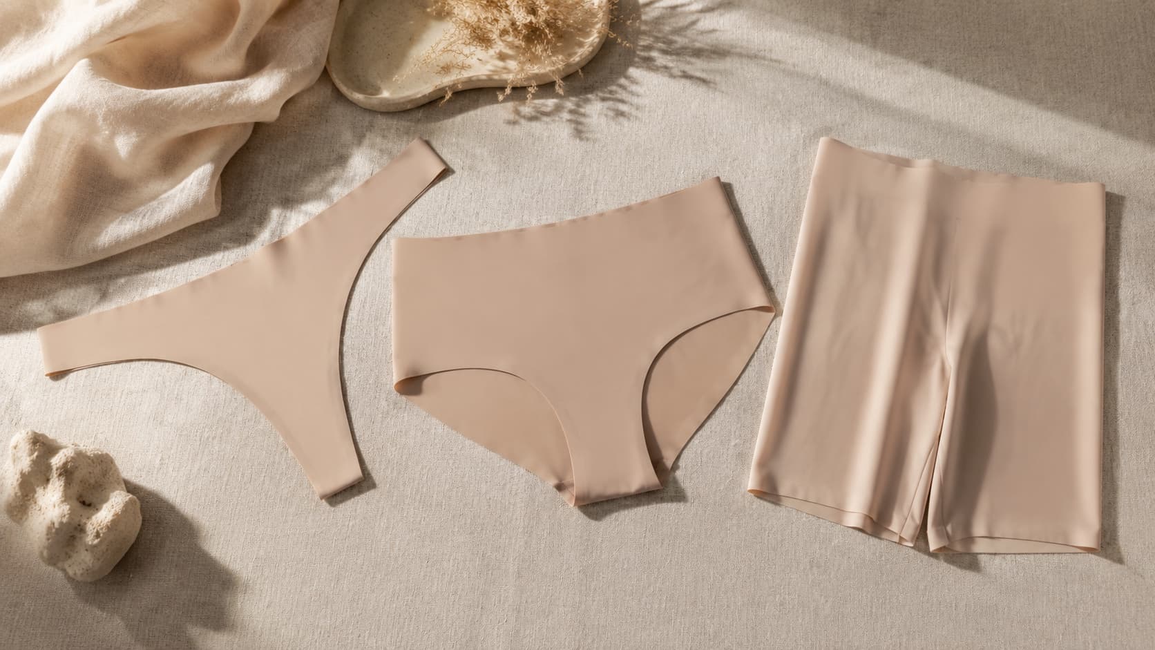 Thong and seamless brief laid flat, comparing no-panty-line underwear cuts